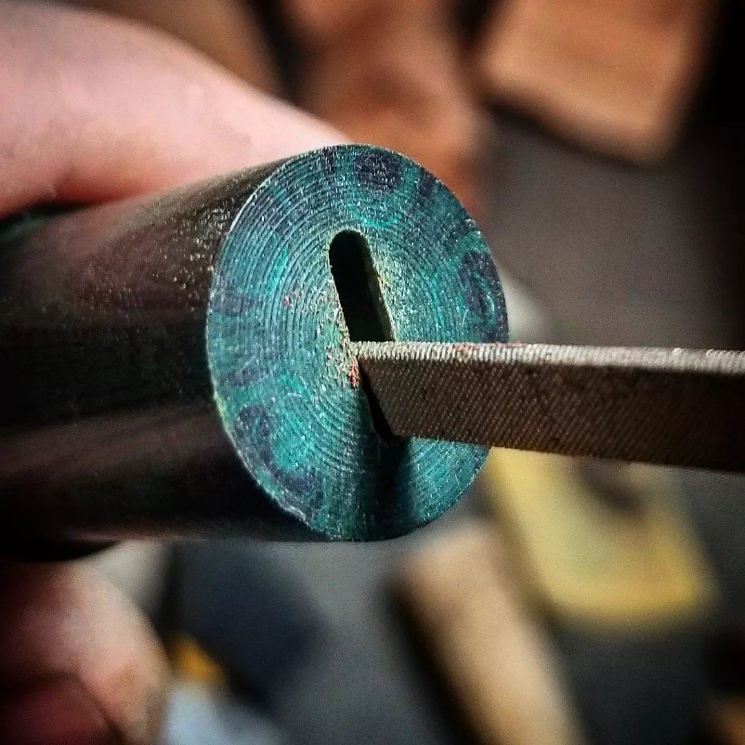 Hand-shaping the slot in an ebonite pipe stem