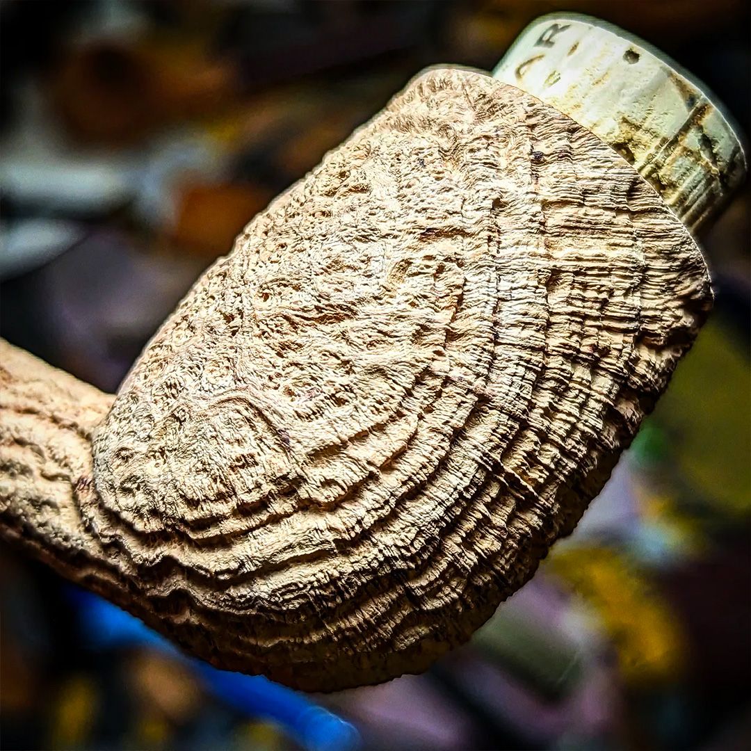 Close-up of deep cross-grain sandblasting on a briar pipe bowl